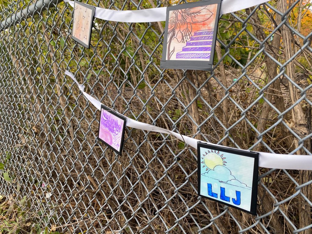 letters strung on fence