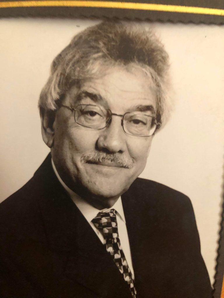 black and white photo of man wearing glasses and a tie