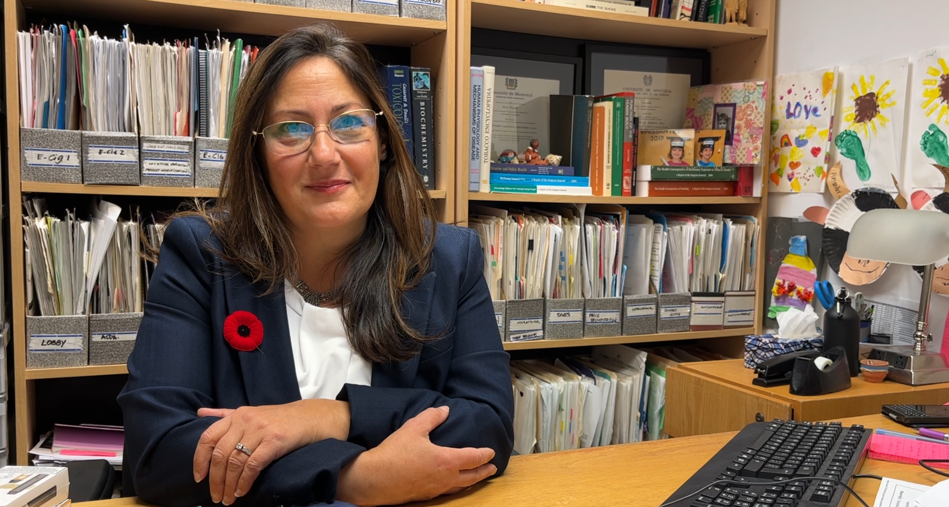 woman sitting at her office smiling at camera 