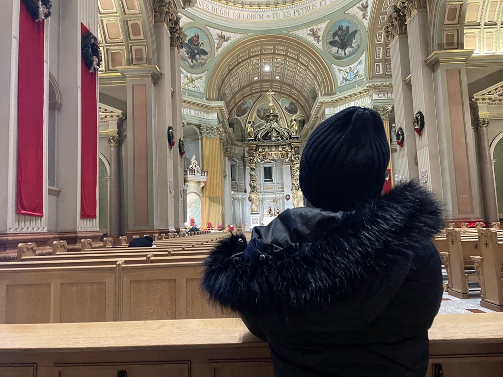 Chantal sits and prays inside Mary Queen of the World Cathedral Chantal sits and prays inside Mary Queen of the World Cathedral