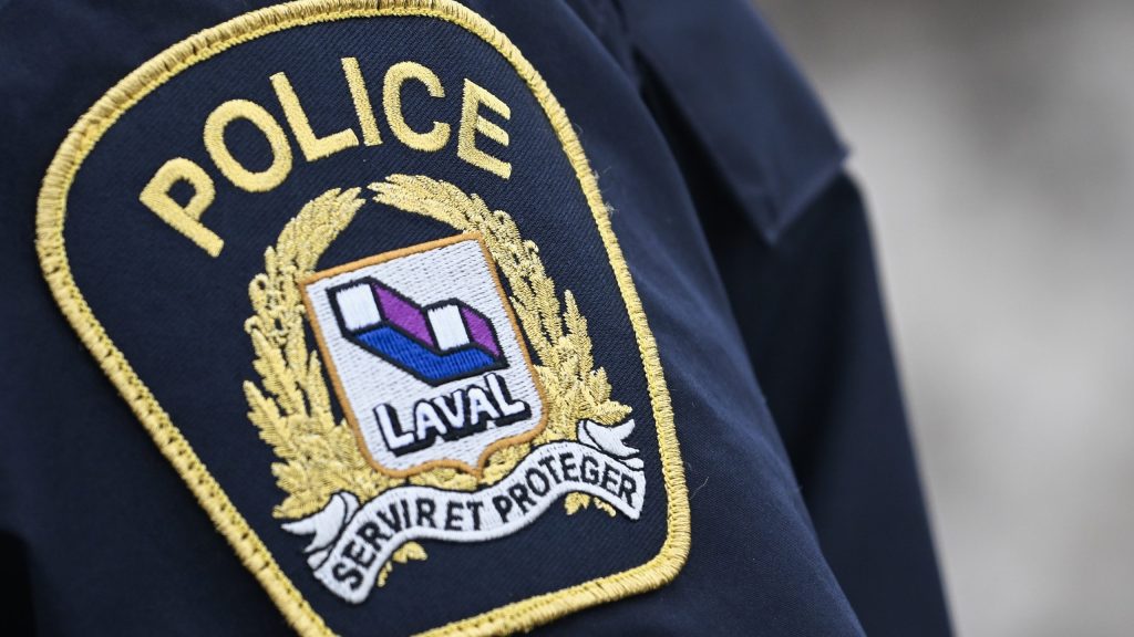 closeup of laval police badge on officer's shoulder