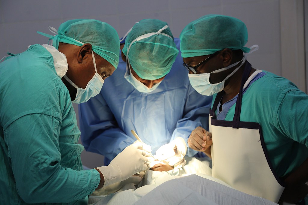 a group of doctors performing surgery.