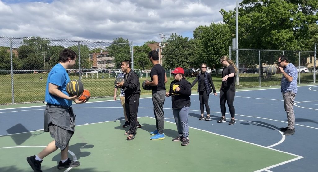 Some members of Power Buddies MTL playing basketball