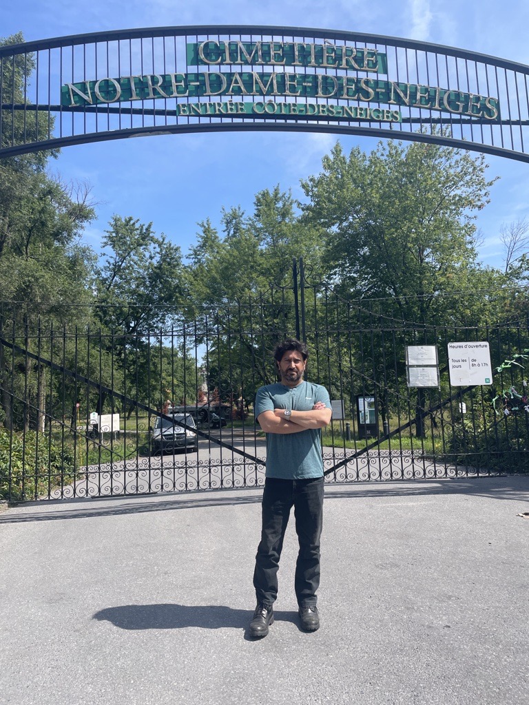 Jimmy Koliakoudakis stands in front of Montreal’s Notre-Dame-des-Neiges cemetery gates