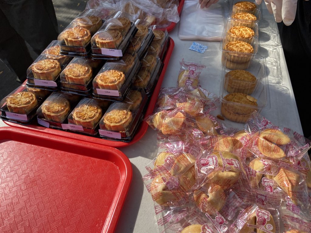 Chinatown residents and merchants distributing free mooncakes to boost public safety