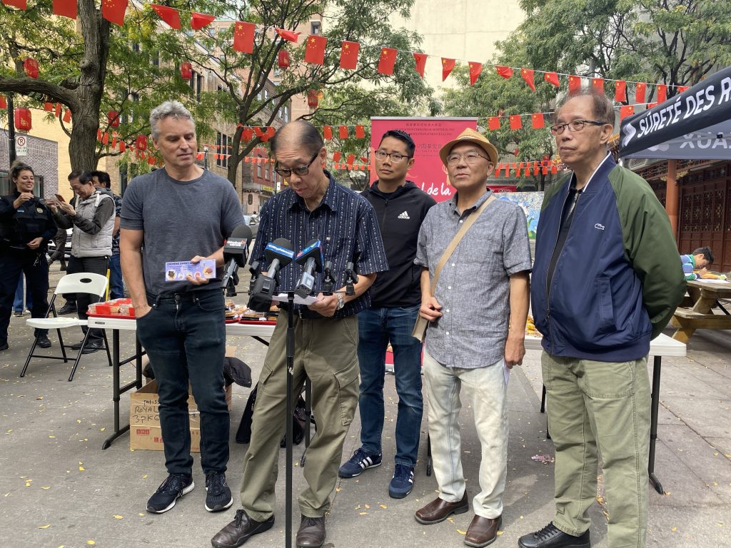 Chinatown residents and merchants distributing free mooncakes to boost public safety