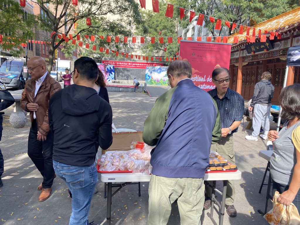 Chinatown residents and merchants distributing free mooncakes to boost public safety