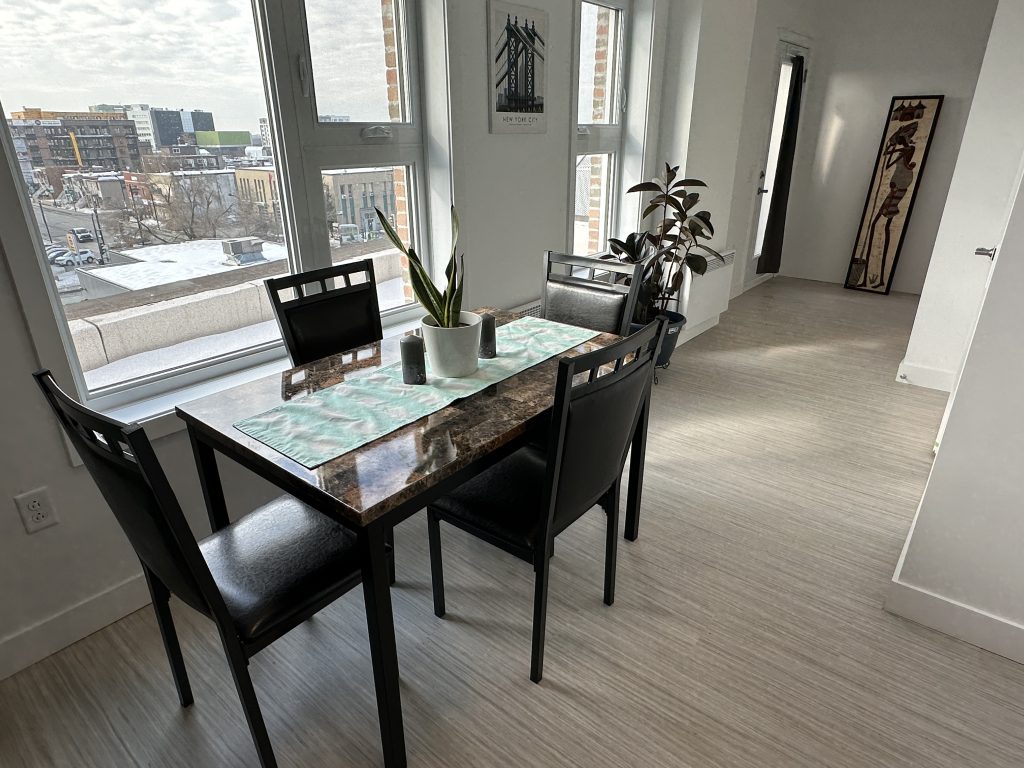 A dining room table is seen in a unit in ShelleyHouse