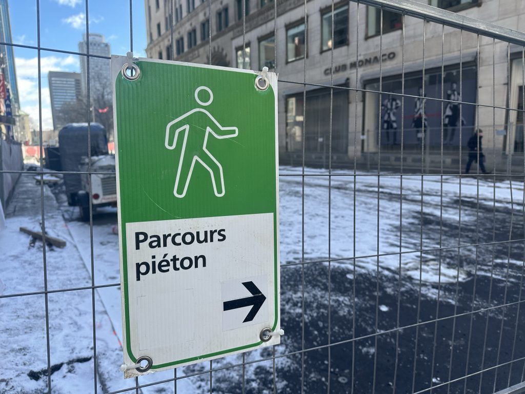 A green pedestrian sign is seen 