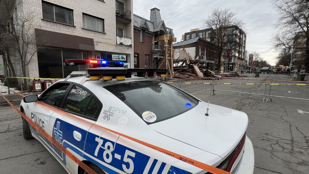 The SPVM is seen parked near a collapsed building