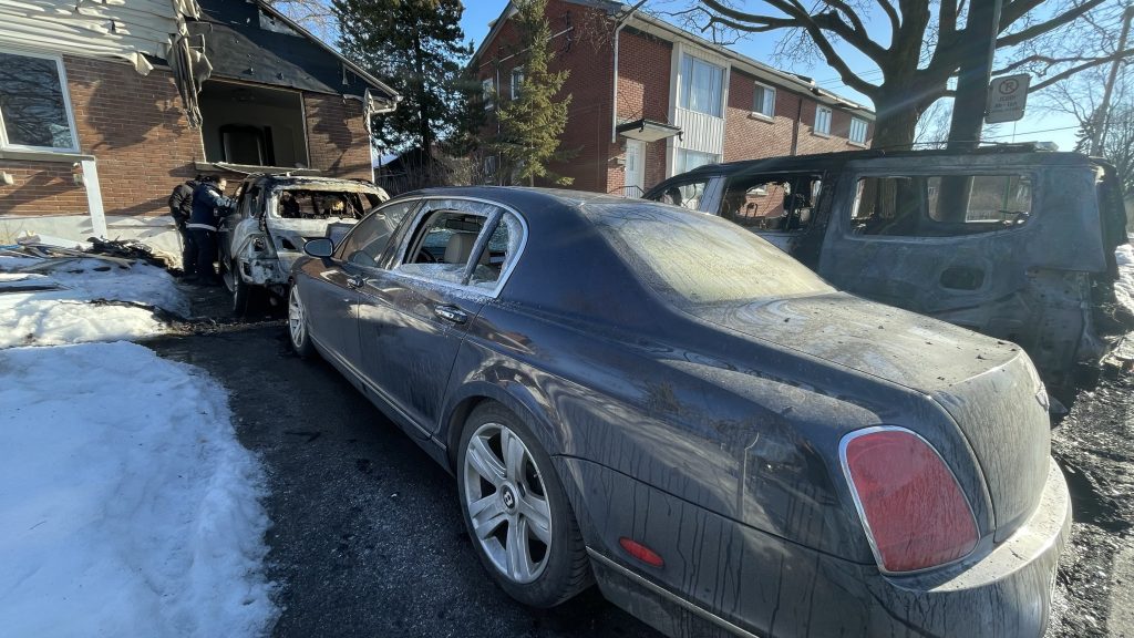 Three cars are seen with fire damage in Saint-Laurent