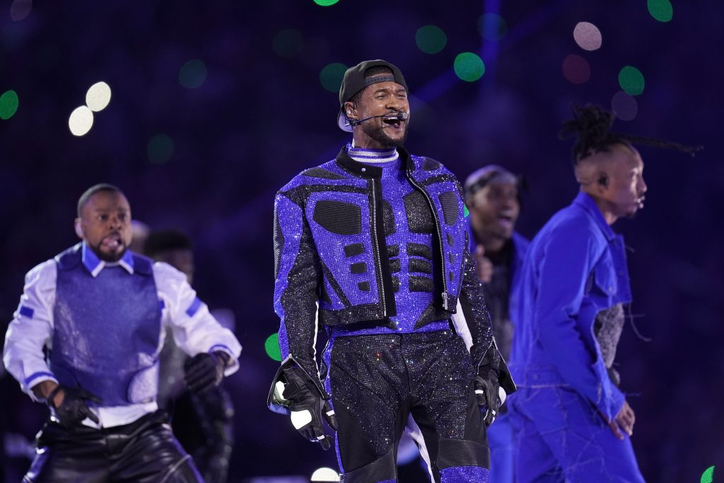 Usher performs during halftime of the NFL Super Bowl 58 football game wearing a purple and black jacket