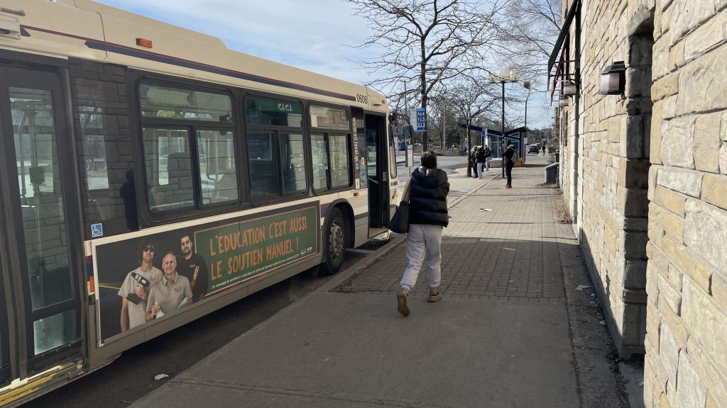 A bus is seen parked at a stop in Saint-Laurent