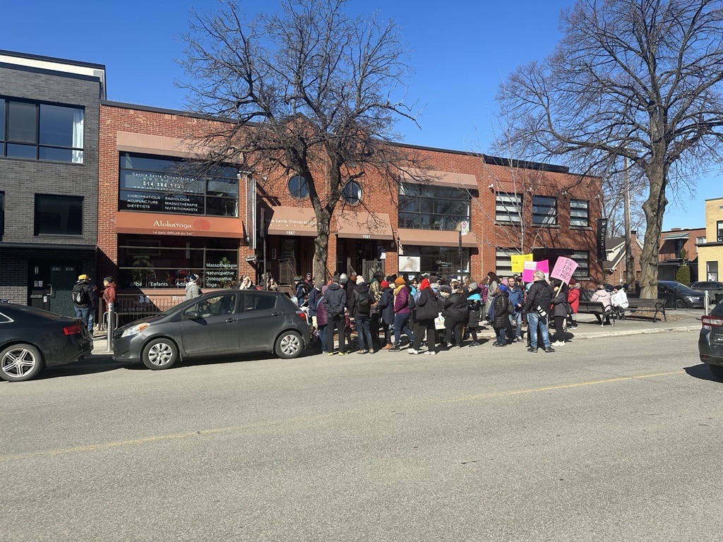 People are seen gathered for a march in celebration of International Women's Day in Ahuntsic