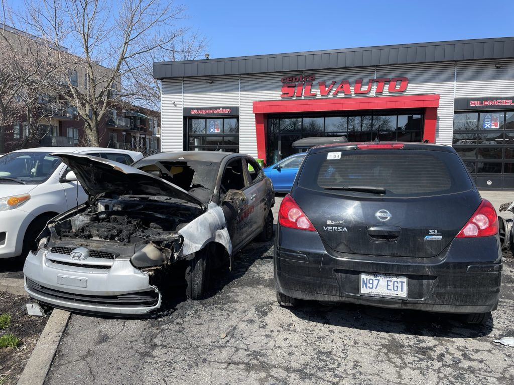 A vehicle with fire damage is seen outside of Centre Silvauto