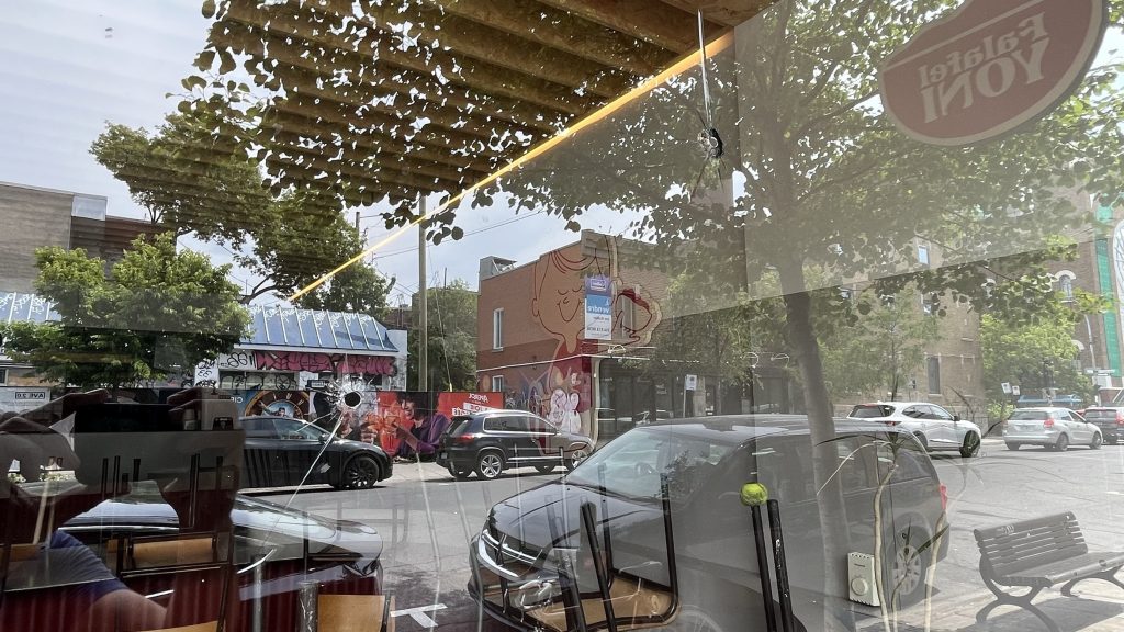 Hole in the window of Falafel Yoni restaurant in Mile End on June 19, 2024. (Martin Daigle, CityNews Image)