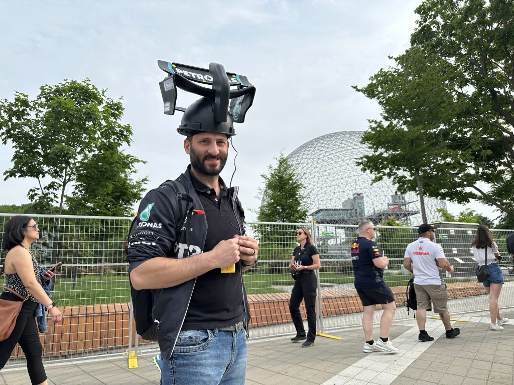A man with a racing hat is seen