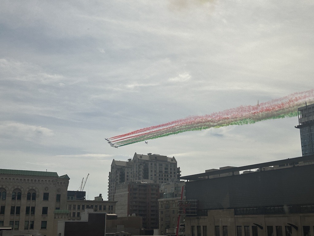 Italian Air Force flies over Montreal leaving the sky green, white and red