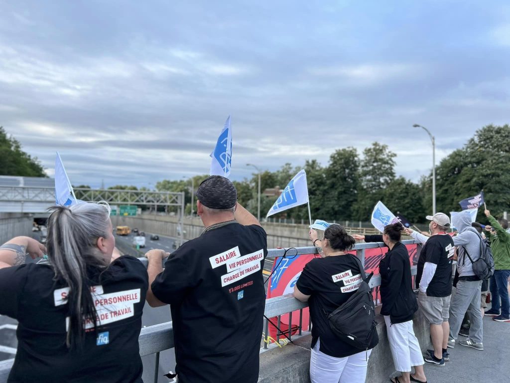 FIQ members protest above the Decarie Expressway