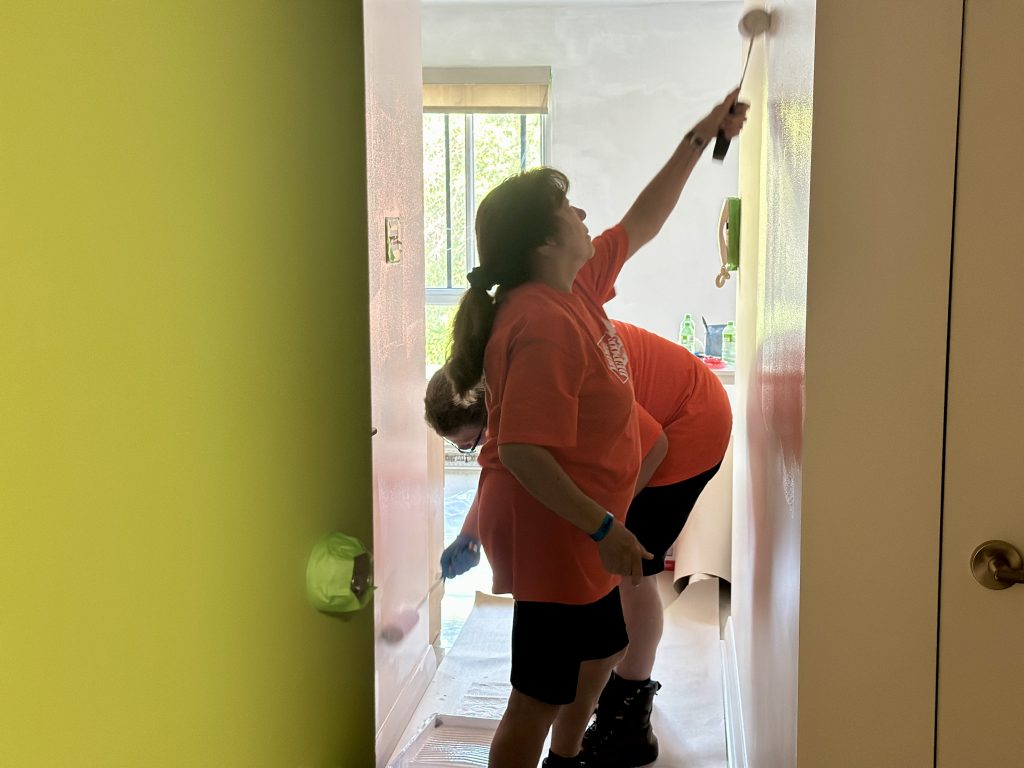 Volunteers paint the walls of an apartment. (Erin Seize, CityNews)