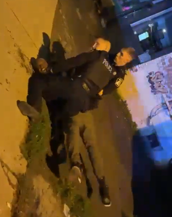 Screen capture of Laval police pinning a man down