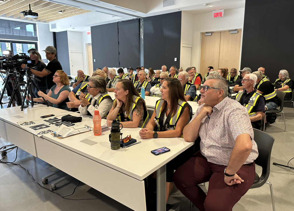 School bus drivers are seen at a press conference