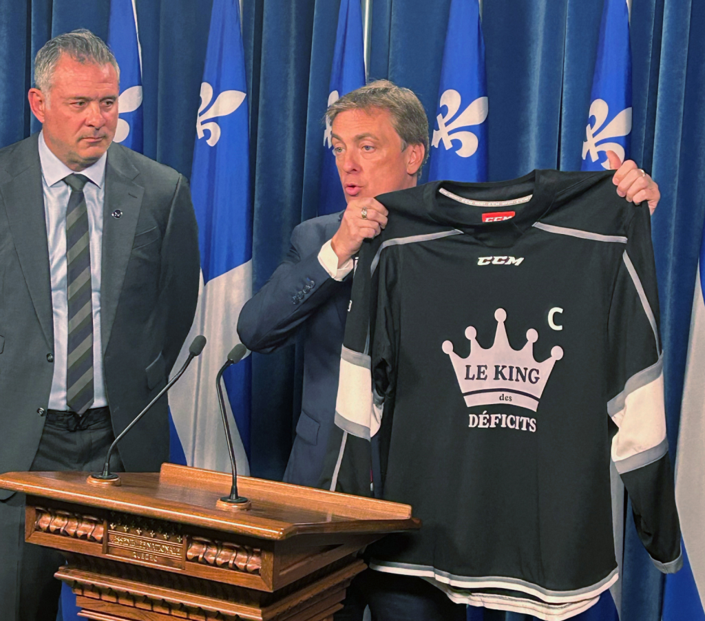 Quebec Liberal Party Interim leader Marc Tanguay holds up a jersey