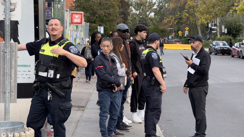 STM worker directing transit users on Friday morning after three blue line metro stations were closed Thursday night. This photo taken outside St-Michel metro station in Montreal. Oct. 4, 2024. (Hayder Mahdy)