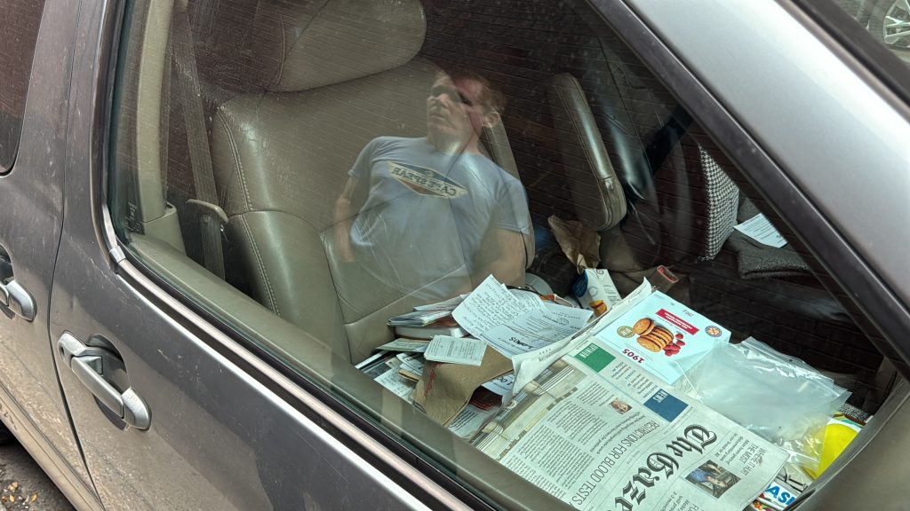 Wayne Adam looks into his car window