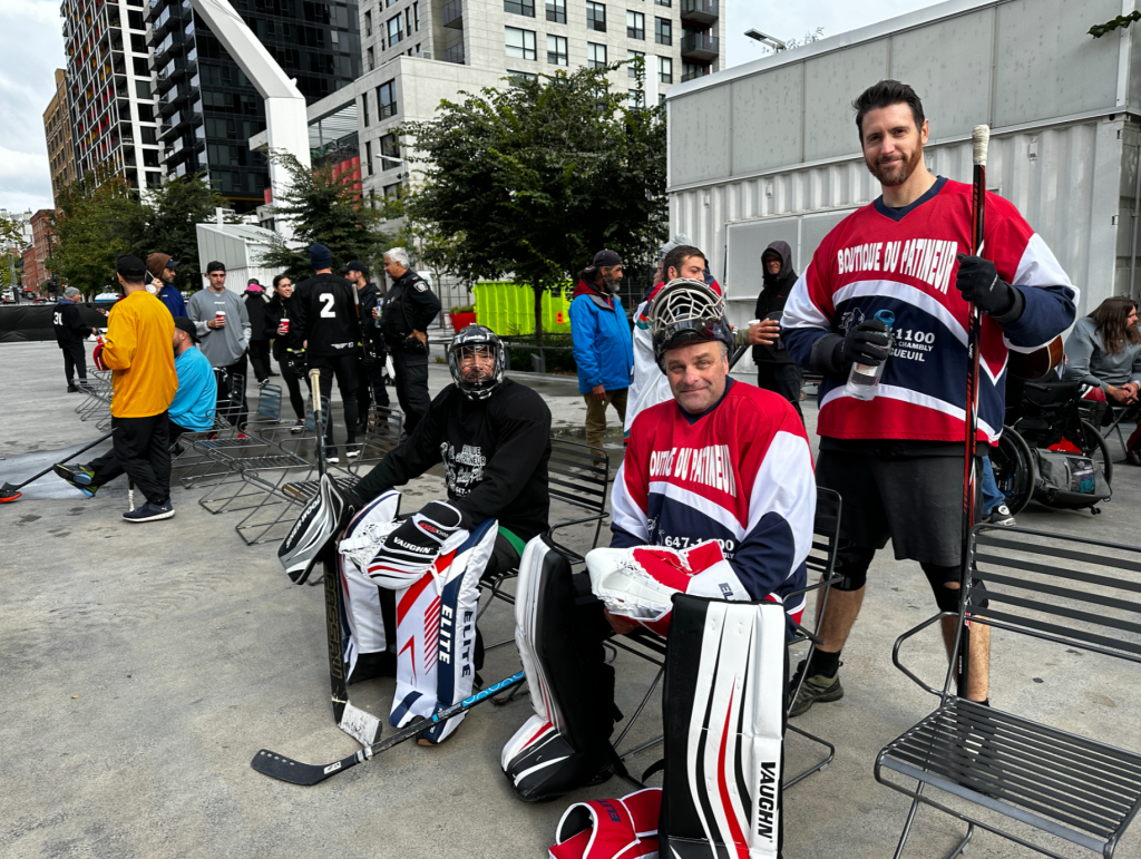 hockey players are seen sitting down in their gear