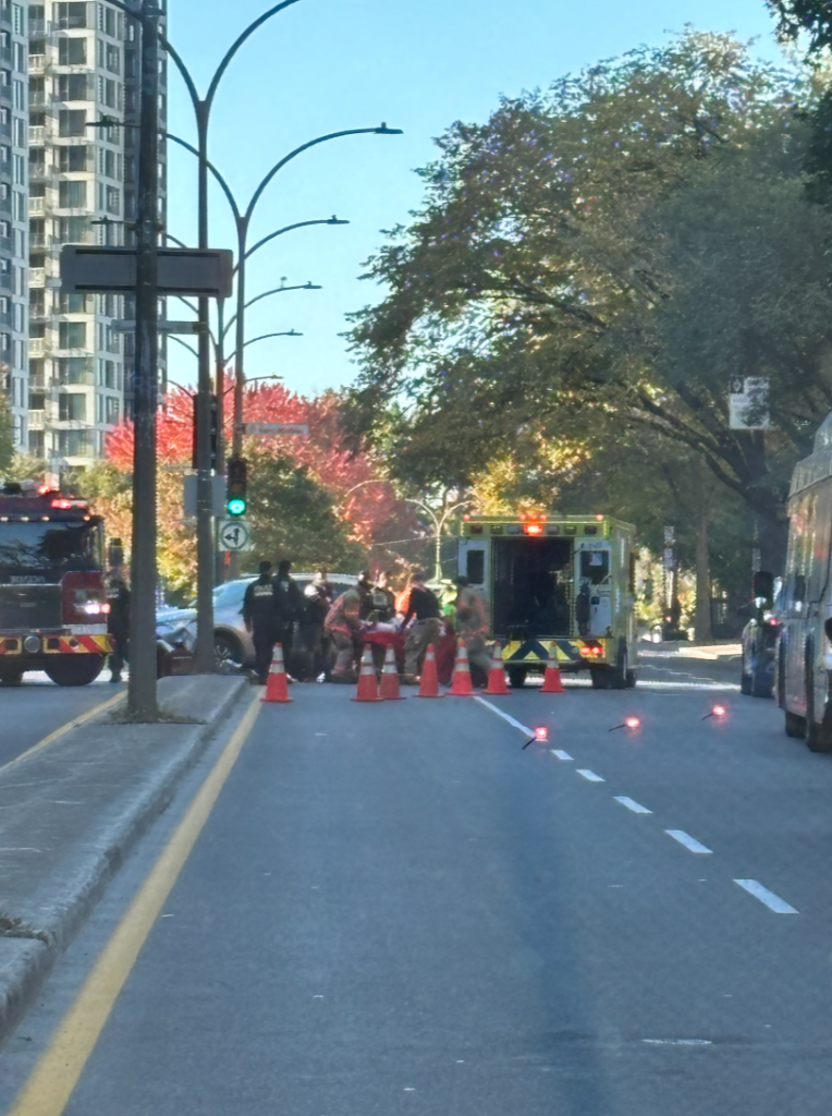 emergency services help a pedestrian after being struck by a vehicle