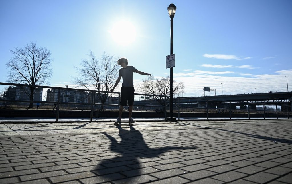 skateboarder riding along the canal