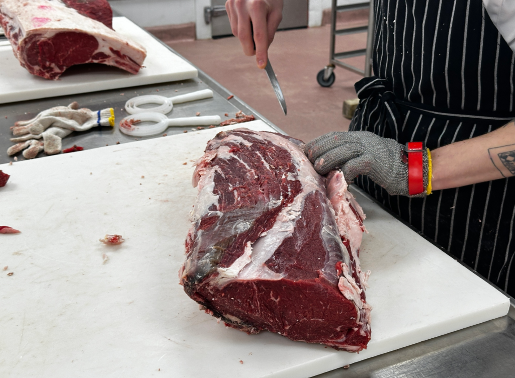 students are seen cutting meat