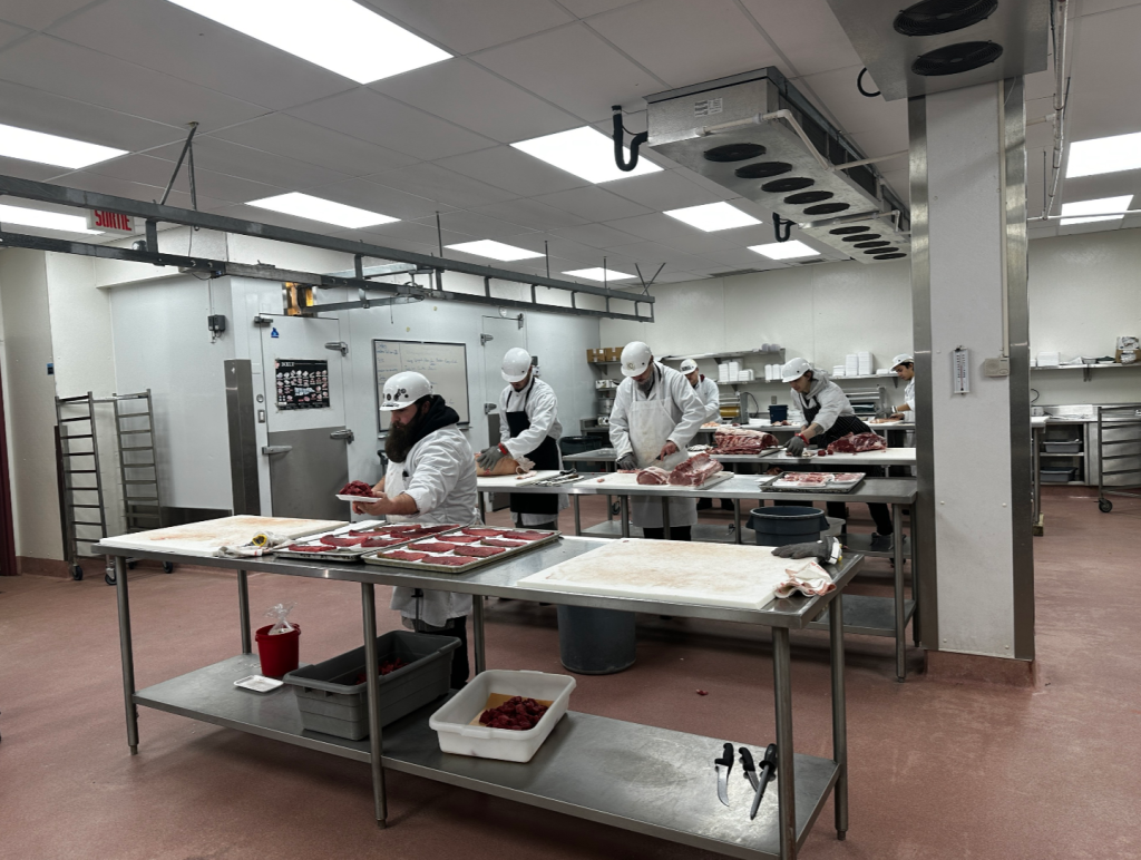 students are seen cutting meat